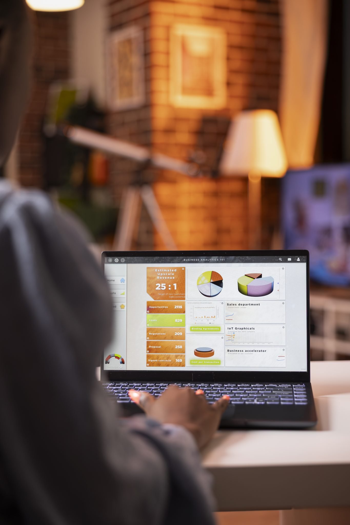Persona analizza dashboard di business analytics su laptop, metriche chiave visibili.